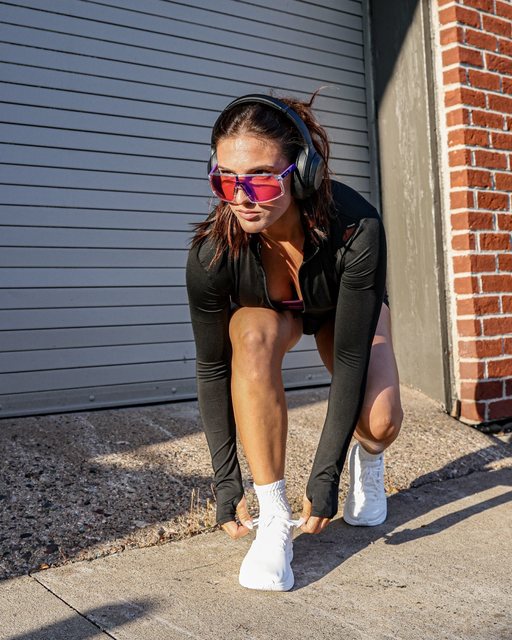 Athlete tying her shoe before a run