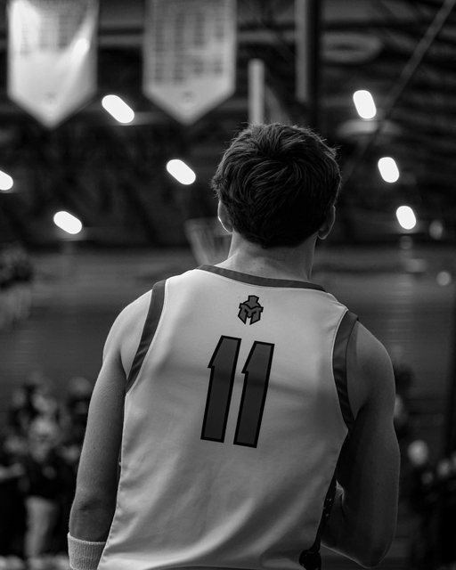 Black-and-white view of basketball player number eleven