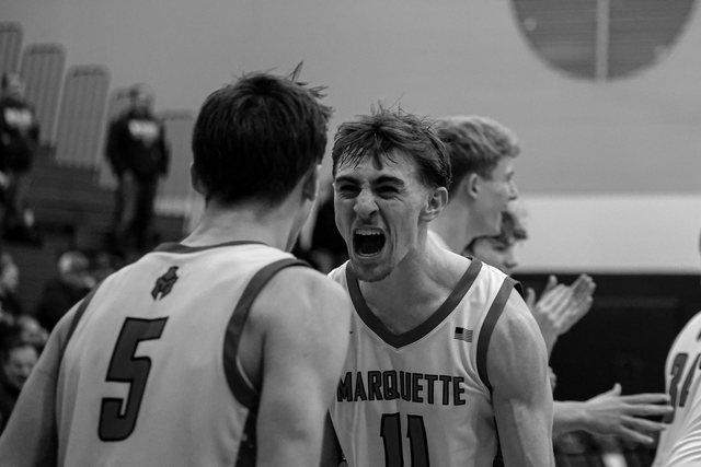 Basketball teammates celebrating together in black and white