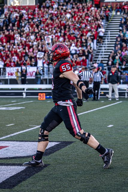 Football player celebrating in front of the crowd