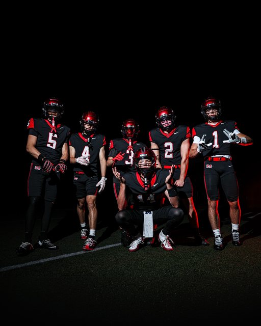 Football team portraits with dramatic red lighting