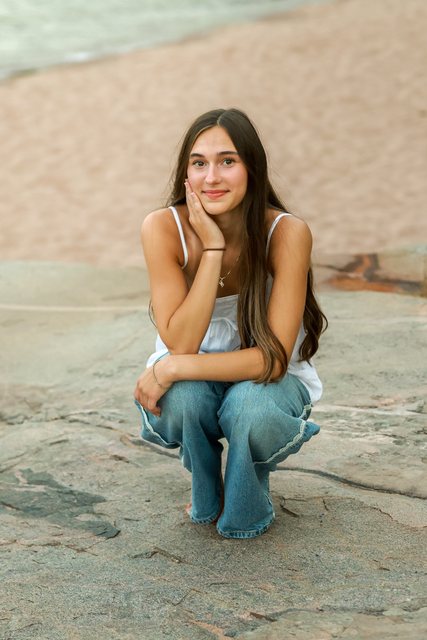 Portrait of a woman seated on rock