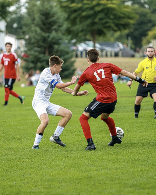 Soccer players challenging for the ball