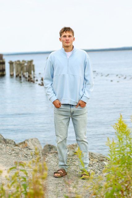 Portrait in a light blue shirt beside the lake