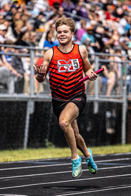 Runner in red and black at the finish of a track race